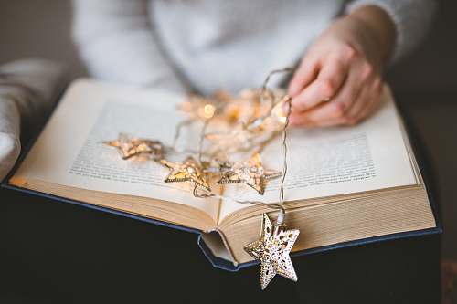 person brown star string lights on book people