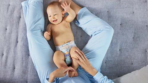 person man playing the baby wearing white diaper diaper