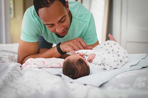 person man playing with the baby baby