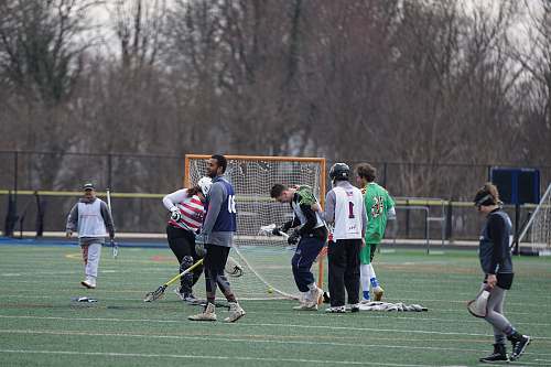 person people playing sports game on field during daytime team sport