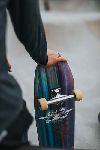 sports person holding skateboard skateboard