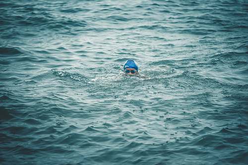 person person swimming on body of water during daytime sport