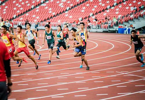 person runners on field running track