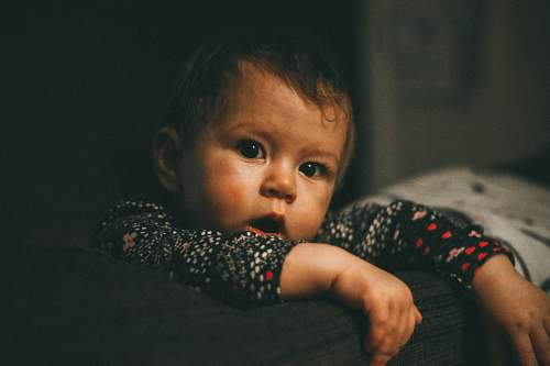 person toddler boy's wearing red and black long-sleeved shirt baby