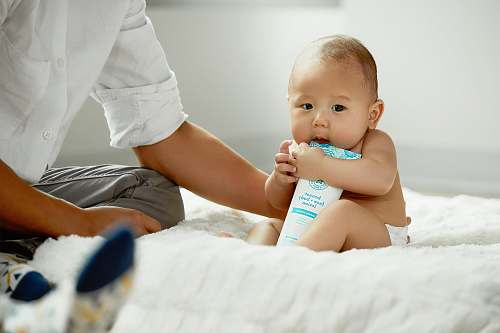 person topless baby hugging white soft-tube baby