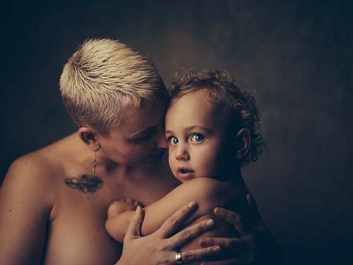 person topless woman holding baby people
