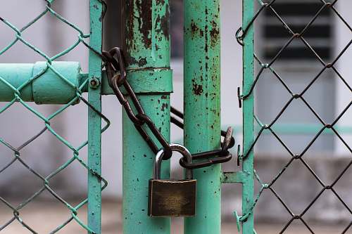rust green metal gate with brown metal padlock gate