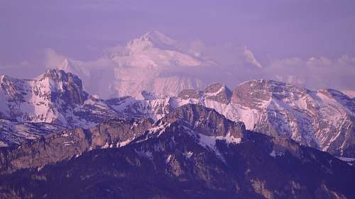 purple landscape photography of mountain covered by snow mountain range
