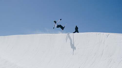 outdoors person doing snow boarding during daytime snow