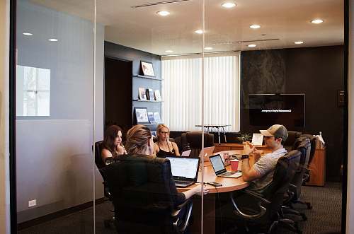 person people sitting near table with laptop computer conference room