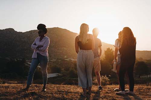 person five person standing near mountain at golden hour human
