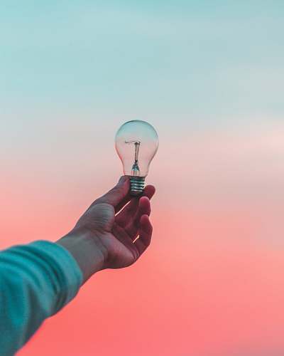 person person holding light bulb idea