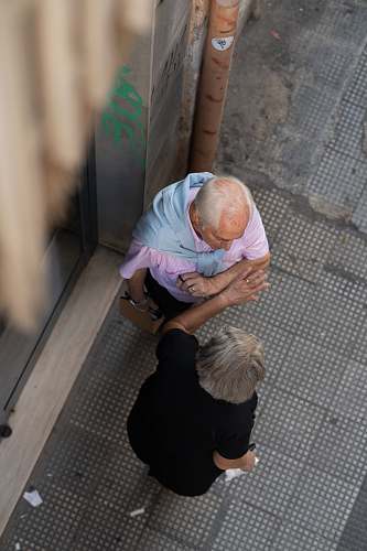 human man and woman talking outside the street during daytime flooring
