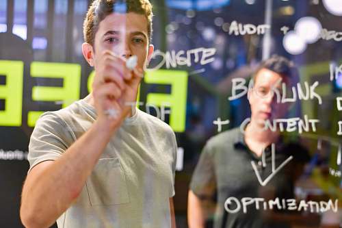 human man writing on glass board apparel