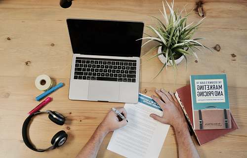 marketing MacBook Pro near headphones potted plant