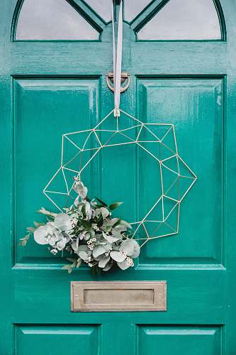 vase white hanging wreath on green door flora