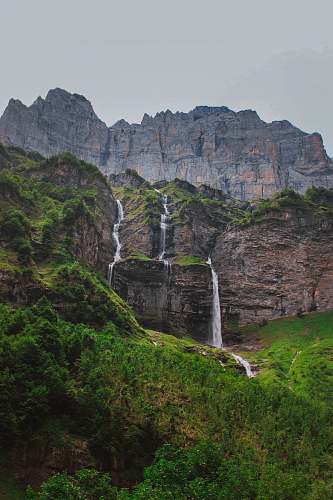 water rock formation above water falls cliff