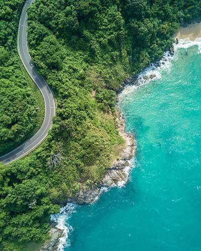 nature bird's eye photography of road near near body of water thailand