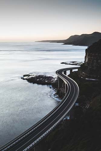 water bird's eye view of curved road sea