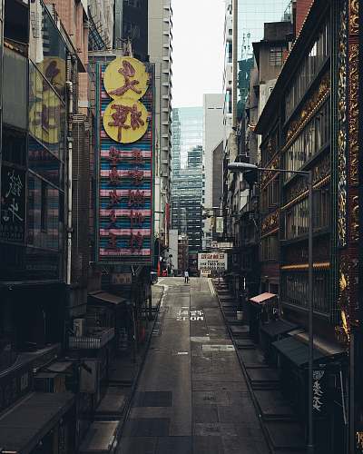 urban gray concrete road between buildings during daytime street