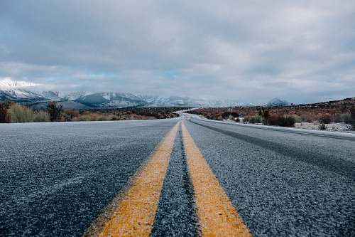 landscape landscape photography of asphalt road under cloudy sky during daytime nature