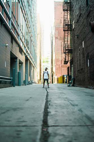 city man standing in middle of road during daytime urban