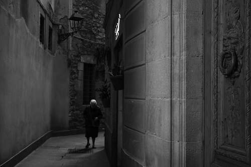 town man walking on dark arlley black-and-white