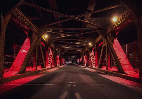 highway red and black metal bridge during nighttime freeway