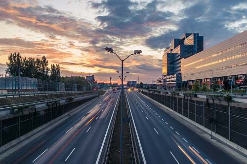 sunset timelapse photo of 2-lane road under golden sky katowice