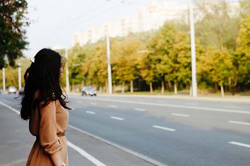woman woman standing beside road looking out