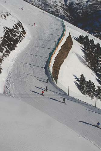 mountain photo of people ice skating during daytime nature