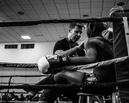black-and-white greyscale photography of a boxer inside reing boxing