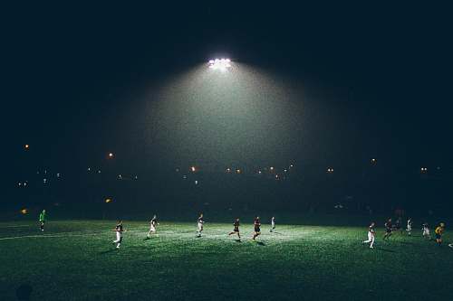 football group of people playing soccer on soccer field soccer