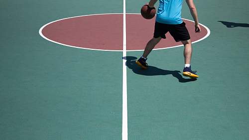 person man dribbling ball on court human