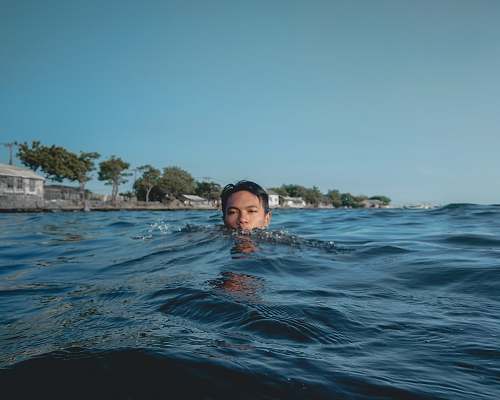 human man on body of water person