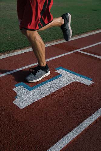 human person running on tracking field sports