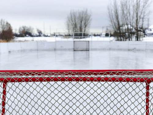 sports red and white goal net on ice field rink