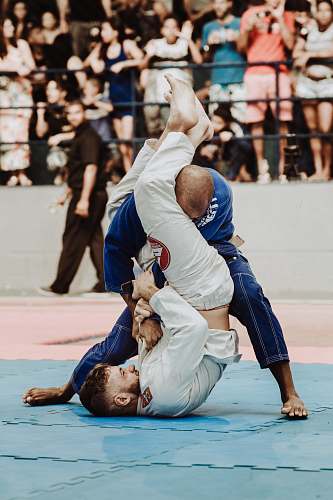 person shallow focus photo of two man playing taekwondo martial arts