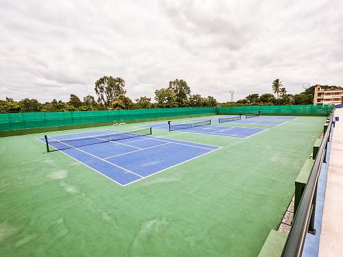 sports three blue lawn tennis courts tennis court