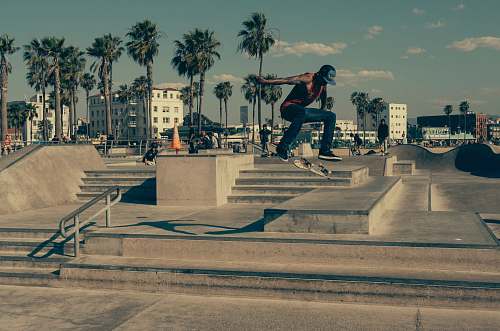 skateboard time lapse photography of man skateboarding outside urban