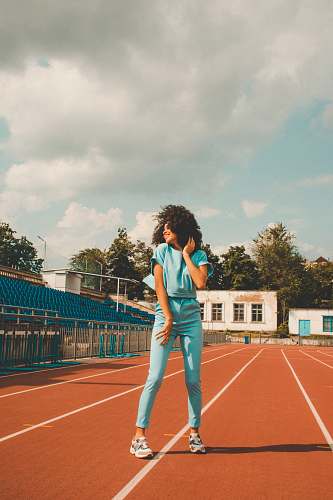 person woman standing near outdoor during daytime running track