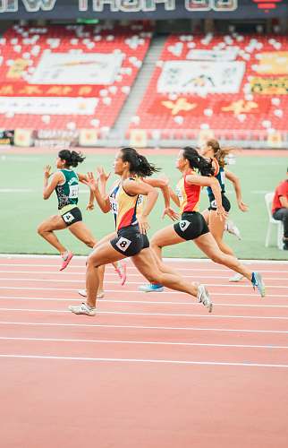 person women running on track field running track