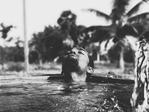 sport grayscale photography of man on body of water black-and-white