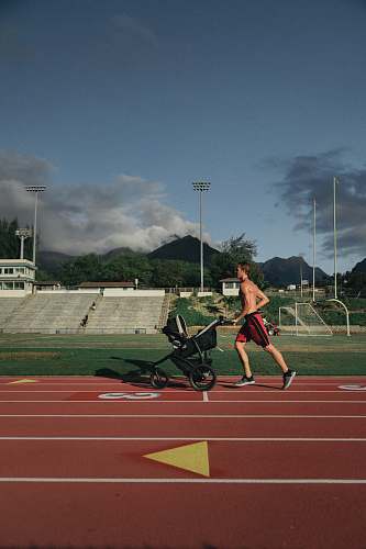 human man running while holding stroller person