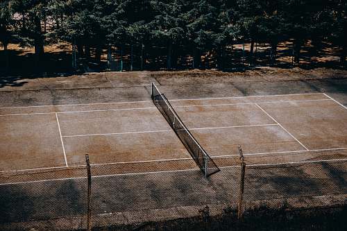 sport tennis court near trees tennis court