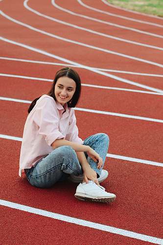 human woman sitting on track running track