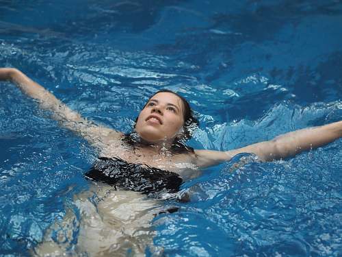 person woman swims backwards at the pool sport