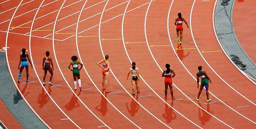 sport women running on race track during daytime running