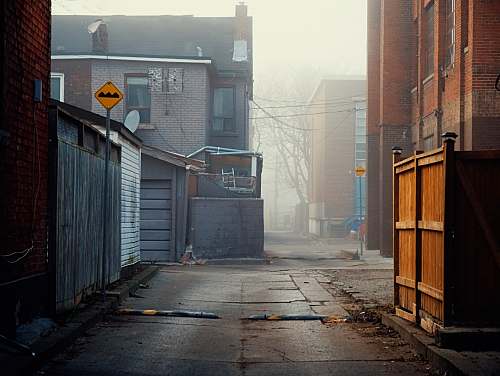building concrete pathway surrounded by house during daytime urban