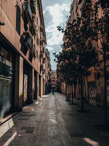 building gray pathway beside brown building urban